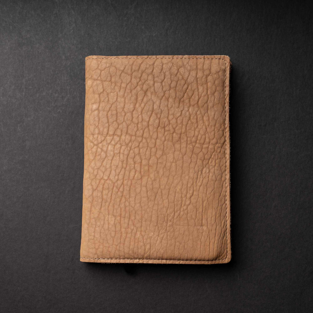 Hand Made Full Grain leather journal cover that comes with a 192 page A5 journal. This journal is handmade and can be personalized with your name or your initials! Made with dark tan shrunken bison leather.