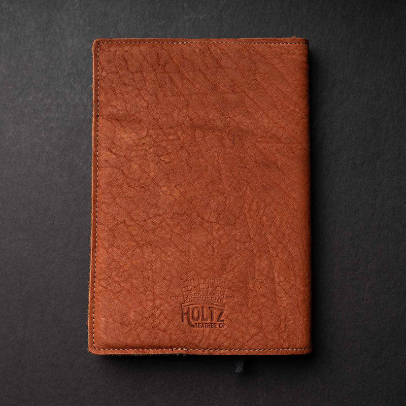 Hand Made Full Grain leather journal cover that comes with a 192 page A5 journal. This journal is handmade and can be personalized with your name or your initials! Made with orange shrunken bison leather.