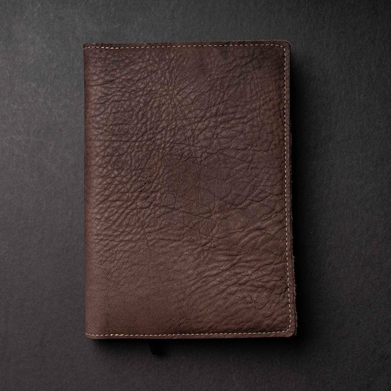 Hand Made Full Grain leather journal cover that comes with a 192 page A5 journal. This journal is handmade and can be personalized with your name or your initials! Made with dark brown shrunken bison leather.